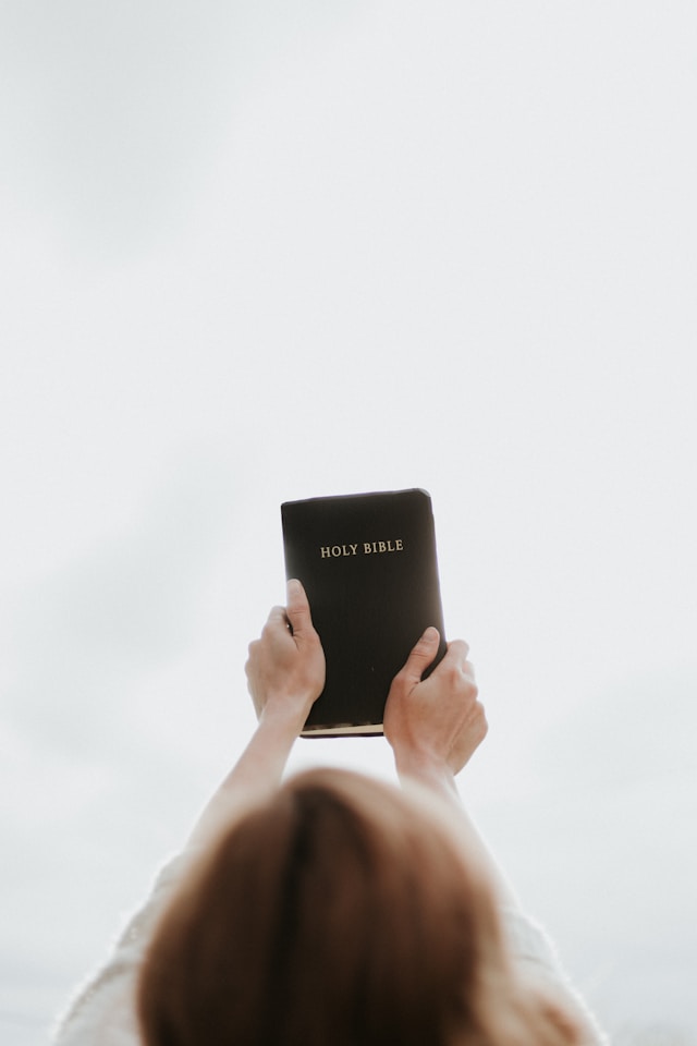 Holding Bible in Hand